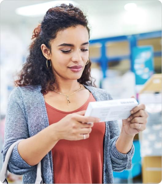 Woman looking at medicine box